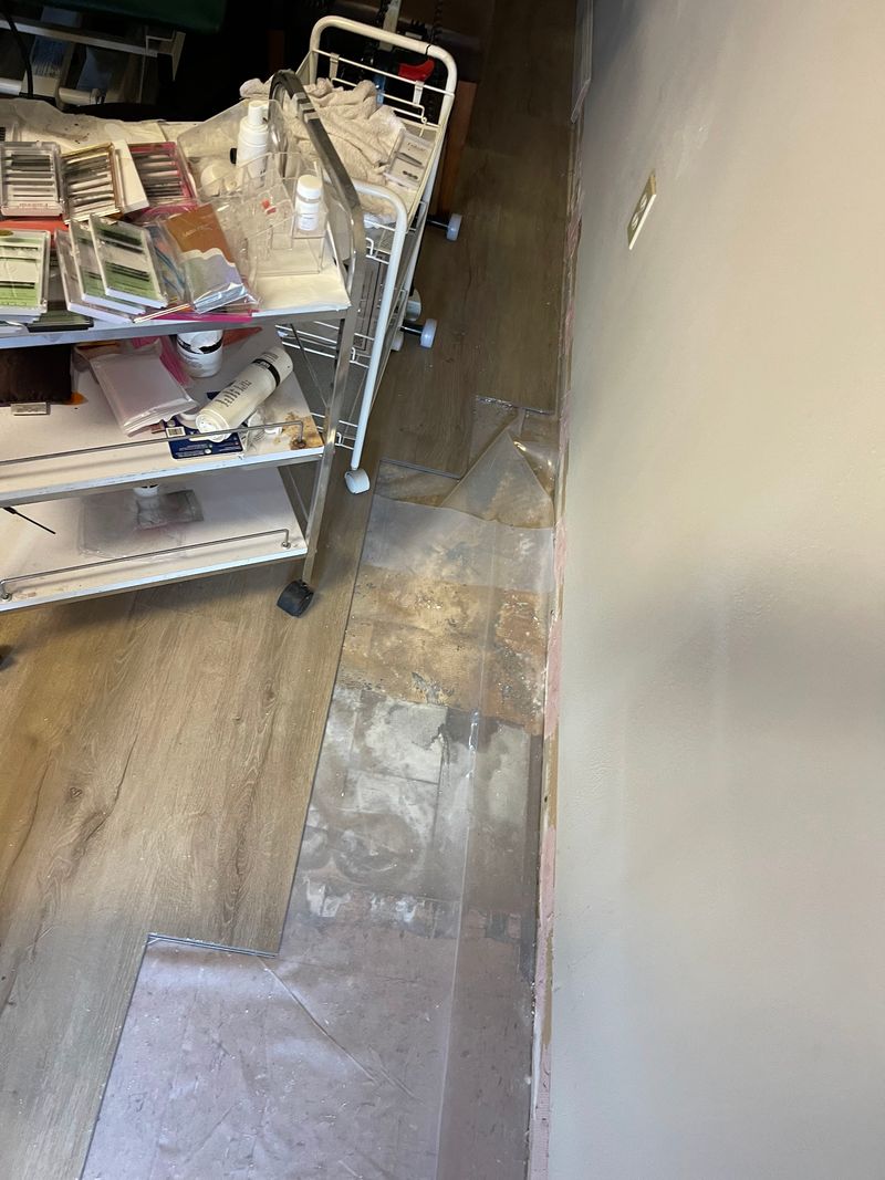 Office room with new light wood-look plank flooring partly installed