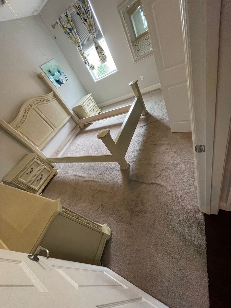 Bedroom with beige carpet and furniture moved aside before the new floor
