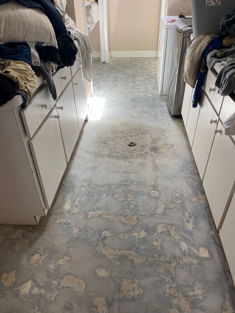 Laundry hallway with tile removed down to the concrete slab