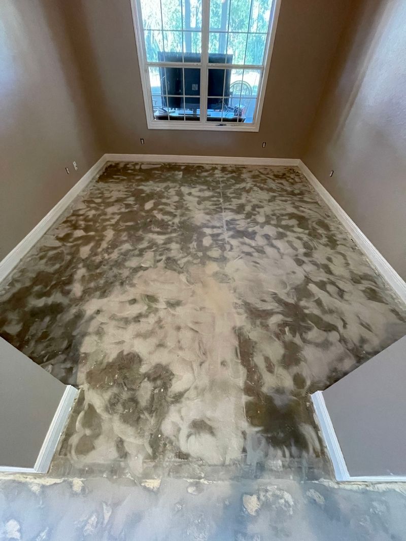 Empty bedroom with old flooring removed and the concrete slab patched and prepped