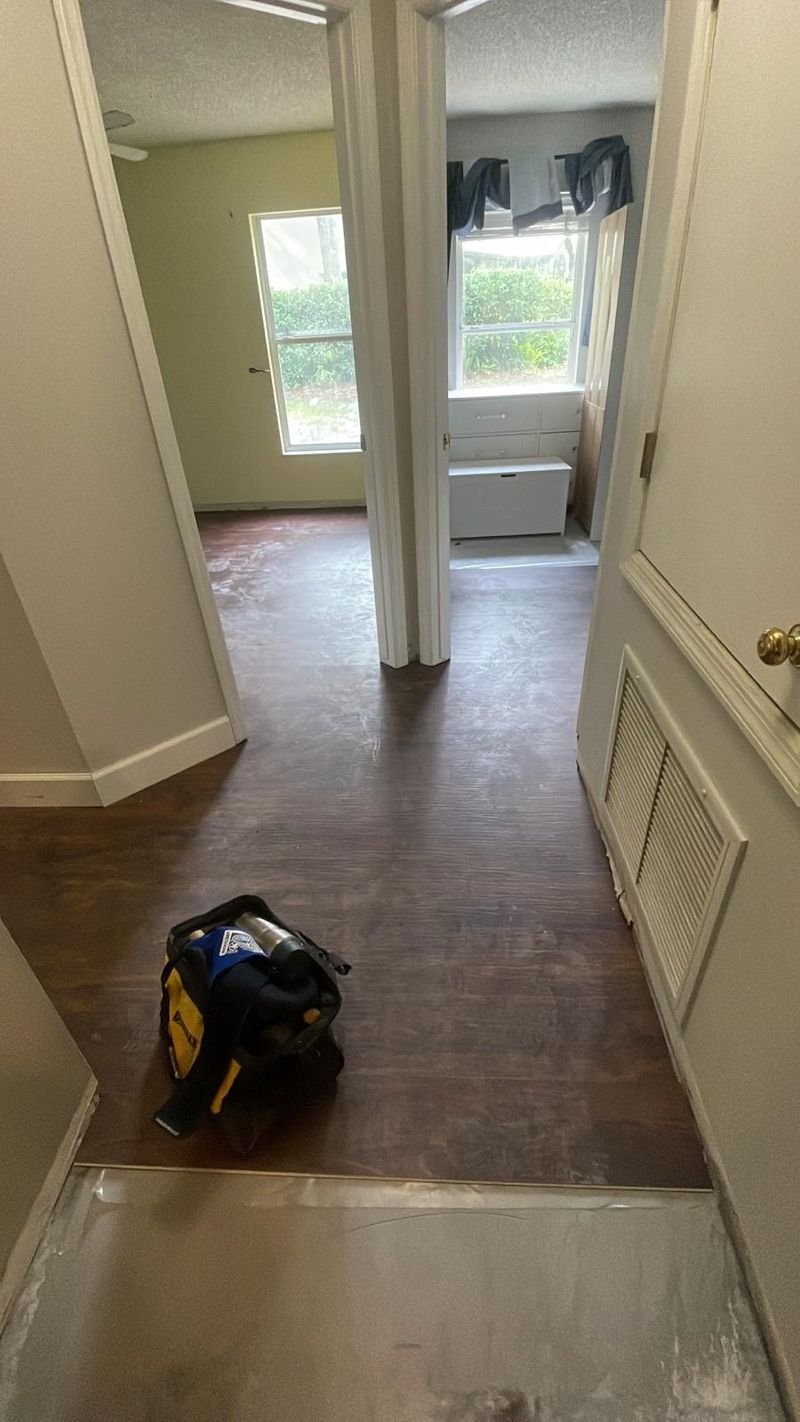 Hallway with new dark brown laminate as installation continues
