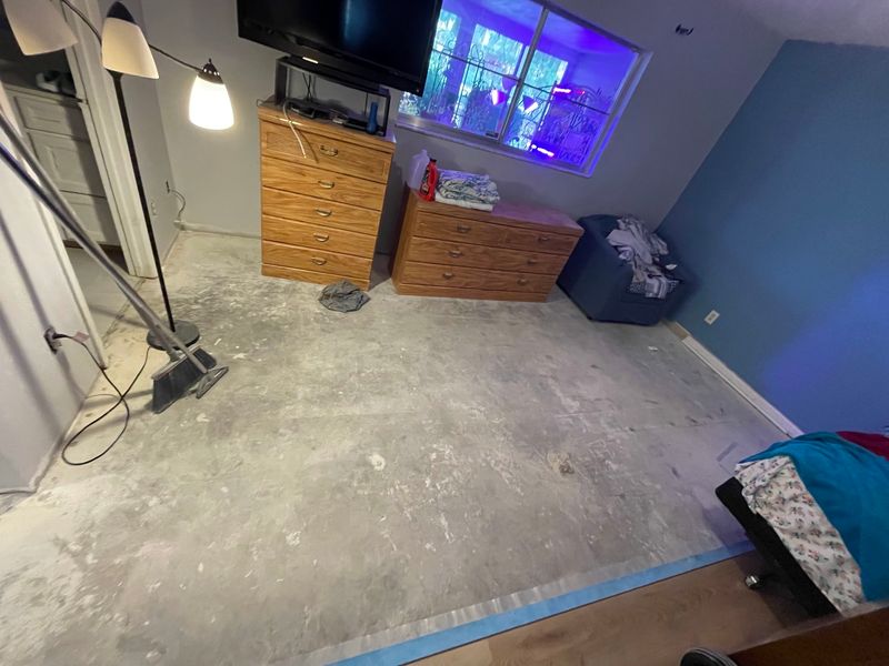 Bedroom cleared down to the bare concrete slab before new flooring