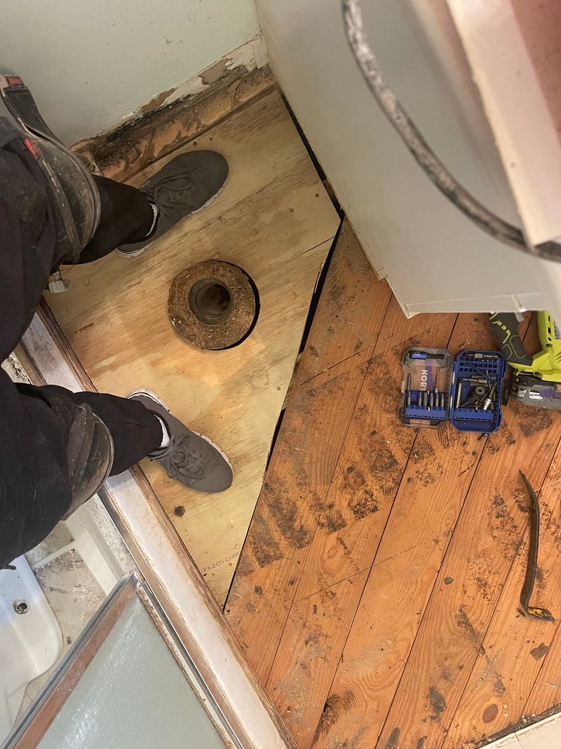 New plywood patch around the toilet flange on the bathroom subfloor