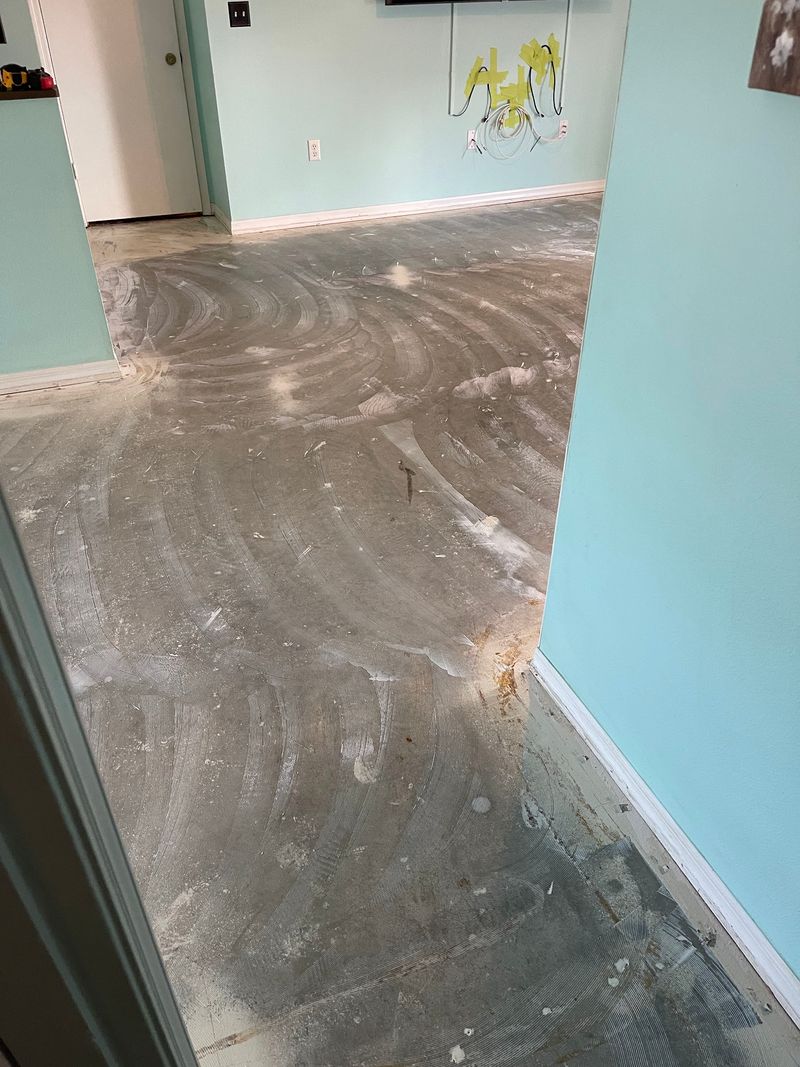 Living area slab scraped bare after old flooring removal