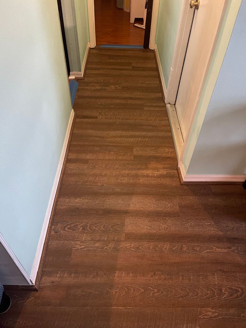 Hallway with new dark brown wood-look vinyl plank flooring