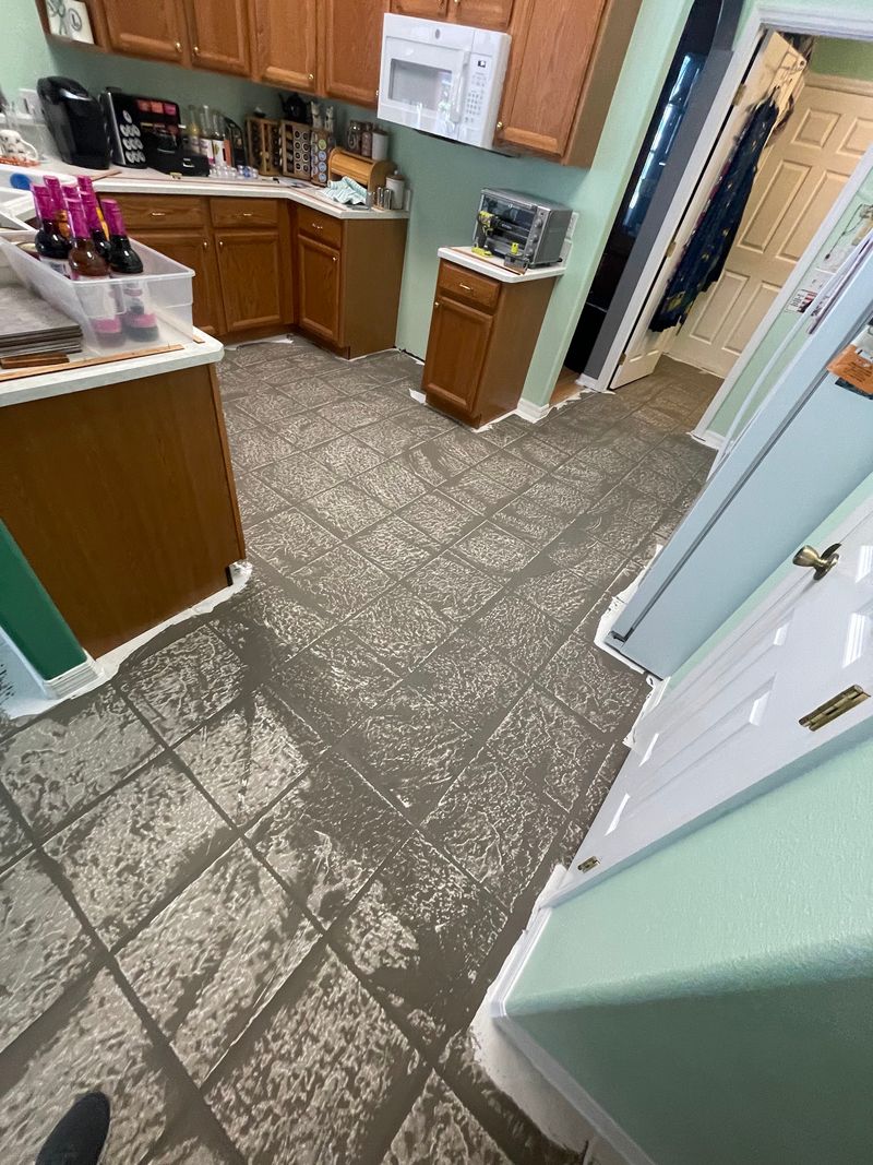 Kitchen floor with leveling compound skimmed over old tile before vinyl
