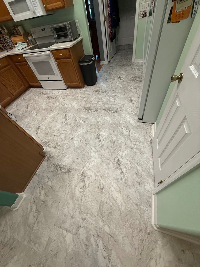 Kitchen with new white and gray stone-look vinyl flooring