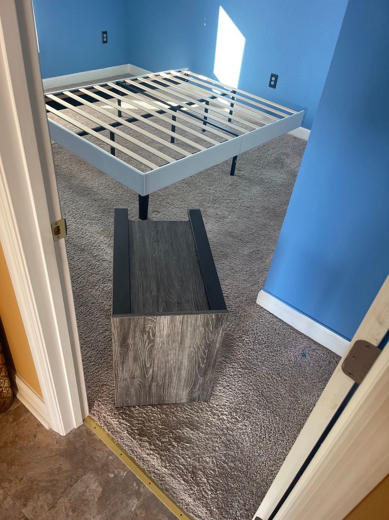 Bedroom with old gray carpet and blue walls before new flooring