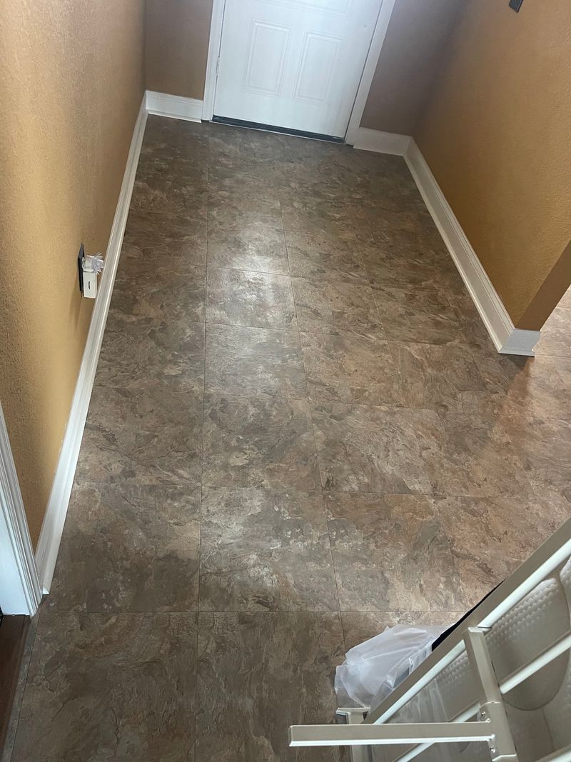 Hallway running to the door with new slate-look vinyl flooring