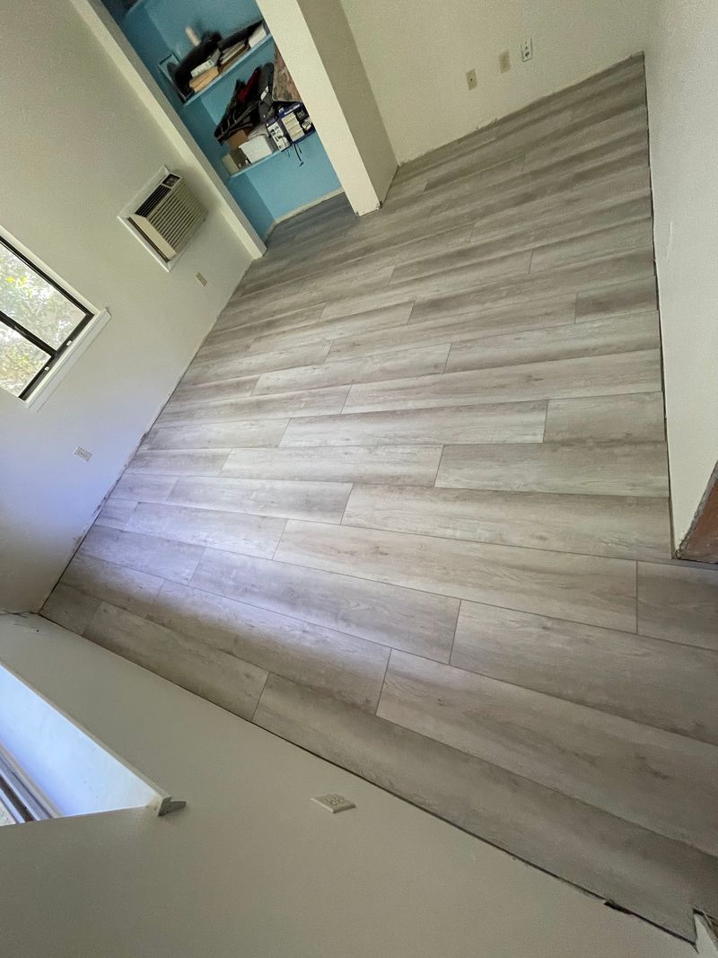 Bright room with long light gray vinyl planks laid edge to edge